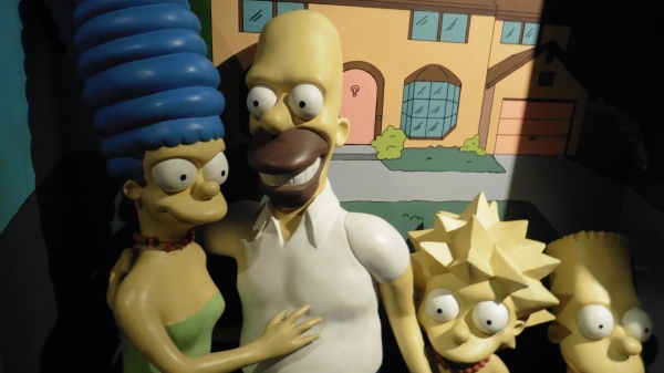 The Simpsons in front of house